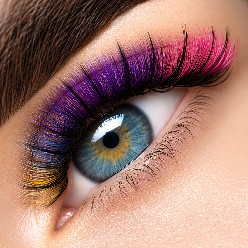 Colored eyelash extensions in purple and pink tones by Cilara Beauty in Richmond Hill